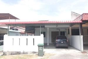 a car parked in a garage in front of a house at Spacious 3bedrooms Holiday House for Family in Pantai Cenang
