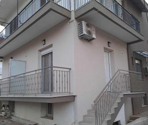 an apartment building with stairs and a air conditioner at Lydia's Apartment in Tripoli