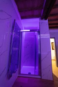 a bathroom with purple lighting in a room at The Rose Suite Siena in Siena +81 photos