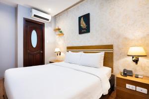Postel nebo postele na pokoji v ubytování Lucky Star Hotel 266 De Tham