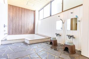 a bathroom with a shower and a bath tub at Guesthouse Sunaen - Vacation STAY 49050v in Tottori