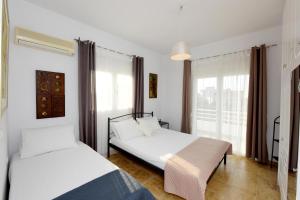 a bedroom with two beds and a window at Emerald Private Villa in Kalavarda Rhodes in Kalavárda +45 photos