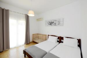two beds in a room with white walls at Emerald Private Villa in Kalavarda Rhodes in Kalavárda