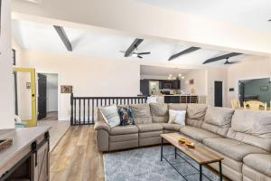 a living room with a couch and a table at Family-friendly cottage with lake access in Chippewa Lake