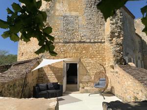 a building with two chairs sitting outside of it at Château de Monsac in Monsac