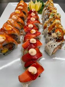 a plate of sushi with fruit and nuts on it at Santantonioresort in Riposto