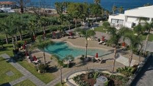 an aerial view of a pool with palm trees at Santantonioresort in Riposto