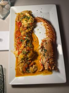 a white plate with a piece of food on it at Santantonioresort in Riposto +46 photos