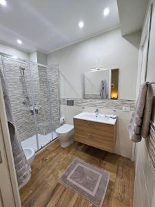 a bathroom with a sink and a shower and a toilet at RC SUITE Annunziata in Termini Imerese