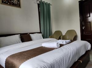 Letto o letti in una camera di Spring Inn Bir-Billing