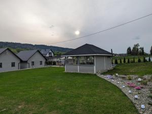a house on a hill with a grass yard at BiesCzadowa Dolina in Ustrzyki Dolne