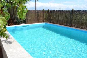 a swimming pool in front of a fence at Bonita casa de campo típica Mallorquina in Sant Jordi +8 photos