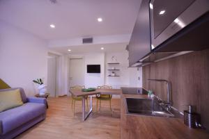 a kitchen and living room with a couch and a table at Santantonioresort in Riposto