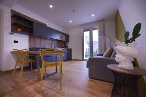 a kitchen and living room with a table and yellow chairs at Santantonioresort in Riposto