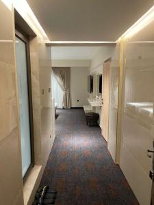 a hallway of a hotel room with a bathroom at Zamzam Hotel 1 in An Najaf +46 photos
