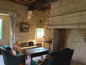 a living room with a couch and a table and chairs at Château de Monsac in Monsac