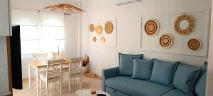 a living room with a blue couch and a table at Villa Pandesia in Afitos
