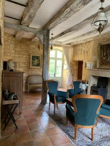 a living room with a table and chairs at Château de Monsac in Monsac