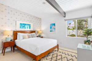 a bedroom with a bed and a window at Alexander on Bedford in Palm Springs