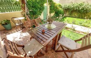 a wooden table and chairs on a patio at 1 Bedroom Cozy Apartment In Toulon in Toulon +7 photos