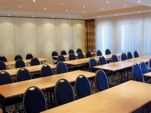 an empty classroom with tables and chairs in it at Schwarzwald Sonnenhof in Schömberg
