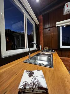 a kitchen with a sink and a counter top at Pousada Vale Das Águias in Jaguaruna +30 photos