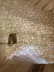 a stone wall with a vase sitting on a shelf at Château de Monsac in Monsac