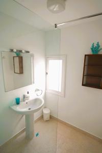 a bathroom with a sink and a glass shower at Timfay in Corralejo