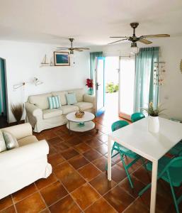 a living room with a couch and a table at Timfay in Corralejo