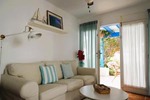 a living room with a couch and a table at Timfay in Corralejo