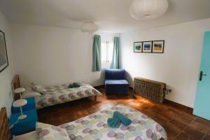 a living room with two beds and a chair at Timfay in Corralejo