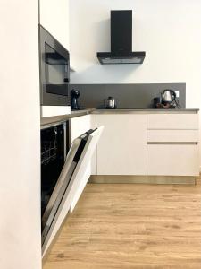 a kitchen with white cabinets and a dishwasher at Appartamento a Quarto D Altino - La Rosa del Sile in Quarto dʼAltino +26 photos