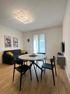 a living room with a table and chairs and a couch at Appartamento a Quarto D Altino - La Rosa del Sile in Quarto dʼAltino