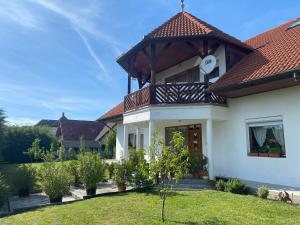 a house with a gazebo on top of it at Juhász Apartman in Gyenesdiás