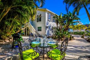 a table and chairs in front of a house at Seaside Serenity in Bradenton Beach
