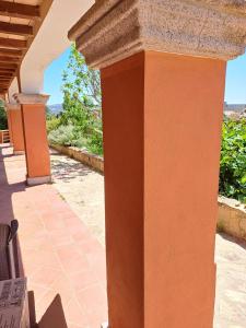 an orange column on a house with a patio at Gelsi Holiday Home La Maddalena in La Maddalena