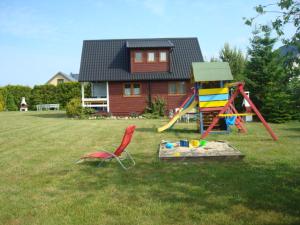 a yard with a playground and a house at Domki Małgorzata in Władysławowo