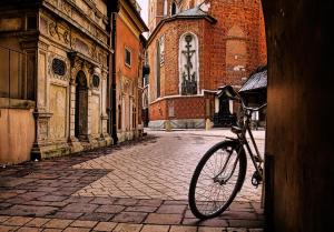 a bike parked in front of a building at JACUZZI SPA Green Apartment in Kraków