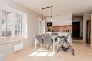a kitchen with a table and chairs in a room at Vingi Familyhouse with free parking and sauna in Pärnu