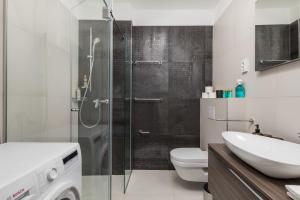 a bathroom with a shower and a toilet and a sink at Luxury apartment Mon Soleil 2 in Murter +40 photos