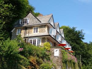 a house on the side of a hill at Chough's Nest Hotel in Lynton