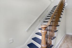a stairway with blue and white stairs at GAGE FARMHOUSE LIMIT 6 apts in Bridgton