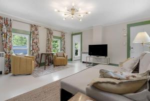 a living room with a couch and a tv at GAGE FARMHOUSE LIMIT 6 apts in Bridgton