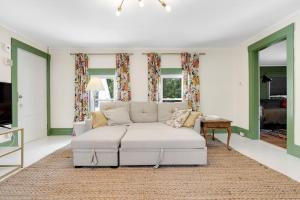 a living room with a couch and a table at GAGE FARMHOUSE LIMIT 6 apts in Bridgton