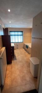 a large room with a sink and a tub at Vakantiehuis Rust & Ruimte in Boekel +15 photos