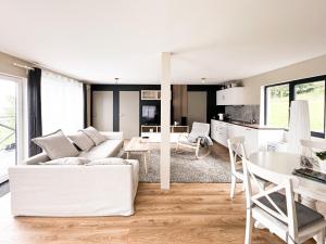 a living room with a white couch and a table at Vēju ritmi in Labvārži