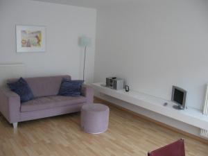 a living room with a couch and a tv at Design Apartment Pandreitje Brugge in Bruges