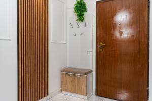 a bathroom with a wooden door and a toilet at Premium Sea View Big Apartament in Durrës +19 photos