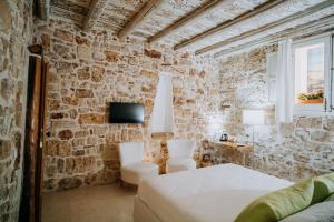 Postel nebo postele na pokoji v ubytování Santuzza Maison De Charme