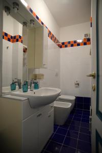 a white bathroom with a sink and a toilet at Il Sestante B&B in Condofuri +79 photos